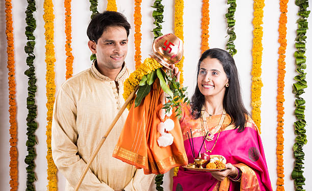 istock smart indian couple performing gudhi padwa puja 516694592