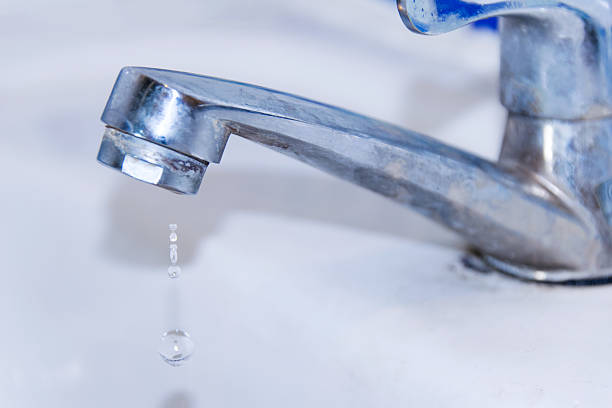 istock Close up faucet and drop water in sink 516694608