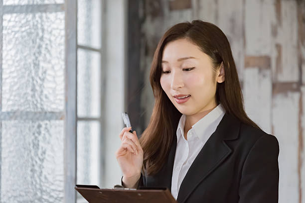 istock Business woman writing on clip-board 516694612