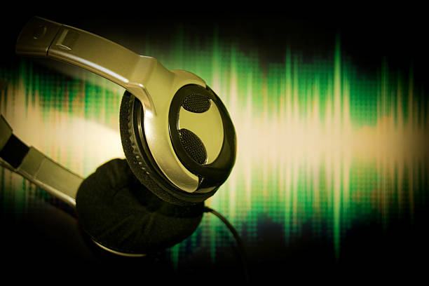istock Close up Headphone, earphone hung on sound wave screen background 516694666