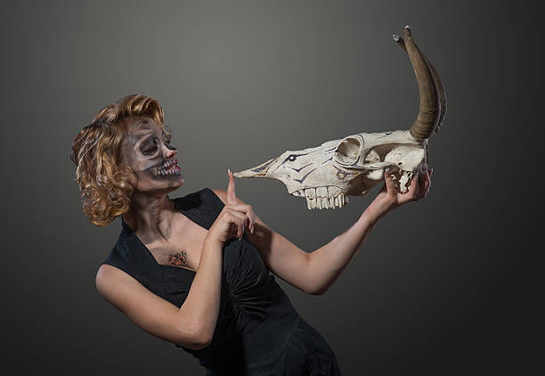 istock Woman with cow's skull in her hands, face to face 516713784