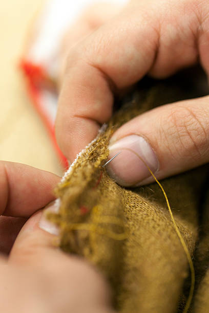 istock Sewing Edges of a Textile with Needle 516713984