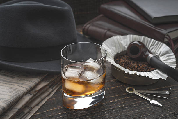 istock Whiskey with ice , pipe hat and newspaper 516714398