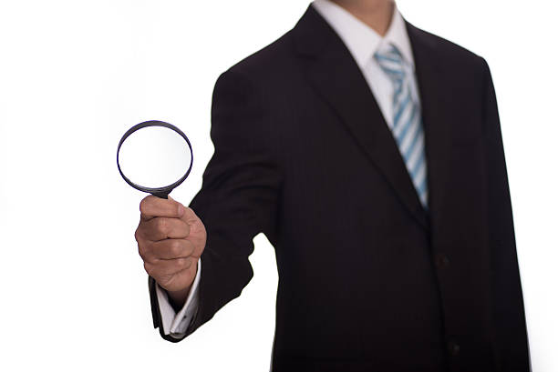 istock Auditor holding magnifying glass and tablet. Over blue background 516715664