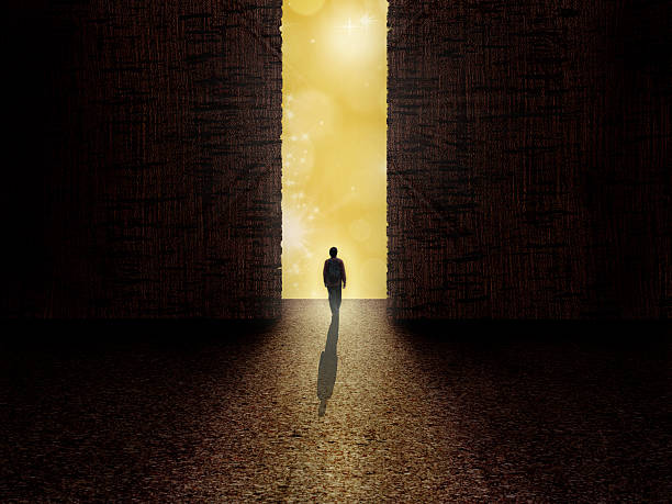 Man standing on the edge of darkness and light