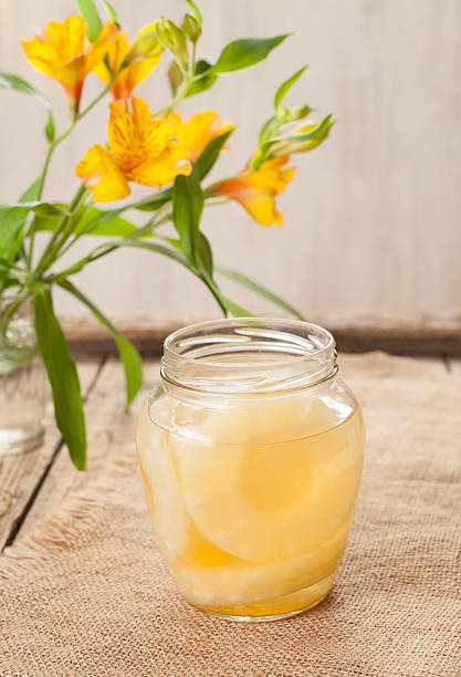 istock Canned pineapple rings in glass with flowers 516716086