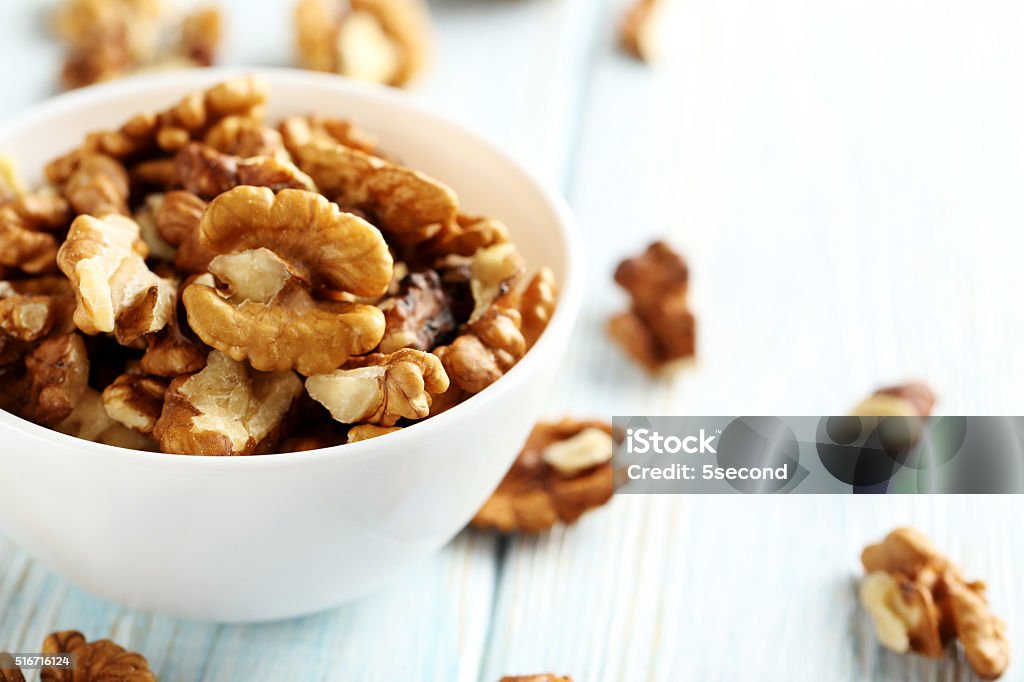 Walnut on a blue wooden table Brown Stock Photo