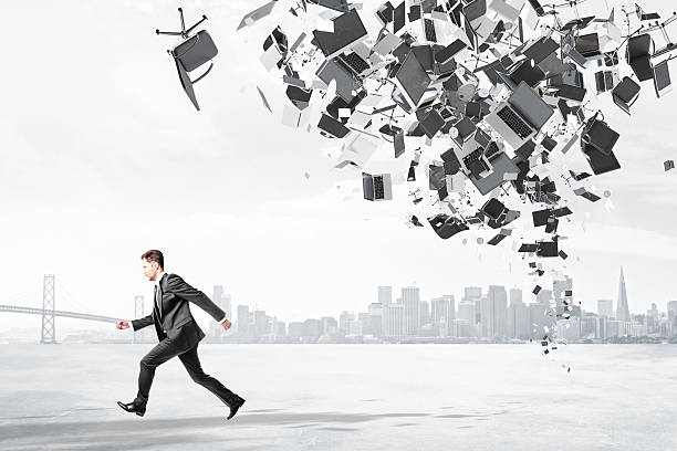 istock Businessman runs from office garbage heap at city background 516716360