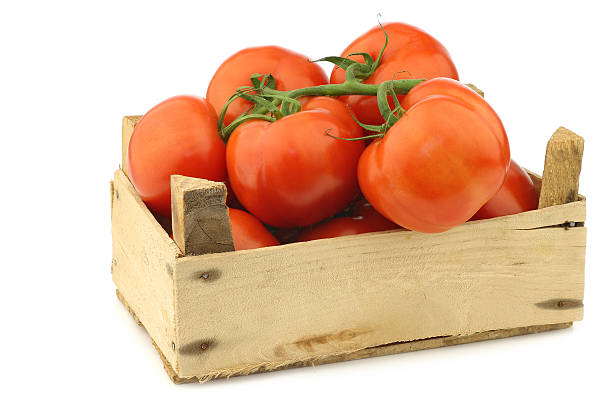 istock fresh tomatoes in a wooden crate 516717226