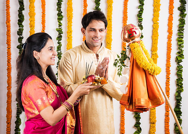 istock smart indian couple performing gudhi padwa puja 516717400