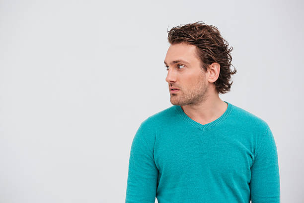 istock Profile of handsome curly young man standing and looking away 516717606