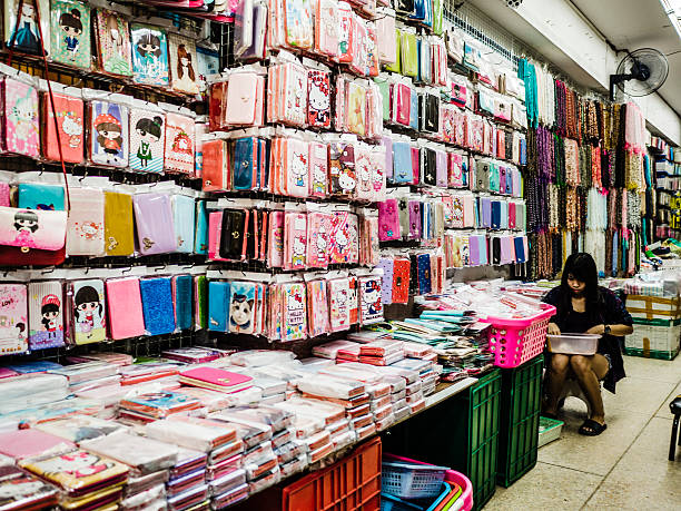 Bangkok, Thailand - February 12, 2016: Vendor inside shop in Sampeng market in Chinatown Bangkok Thailand. This is one of the most popular street markets of the city for locals and tourists 