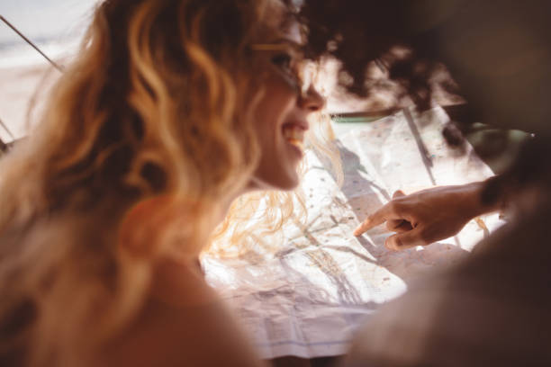 istock Smiling Hipster Friends Looking at Map on their road trip 516720072