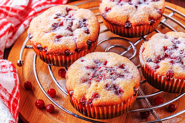 istock Cranberry muffins on a wooden background. 516721566