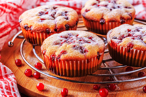 istock Cranberry muffins on a wooden background. 516721724