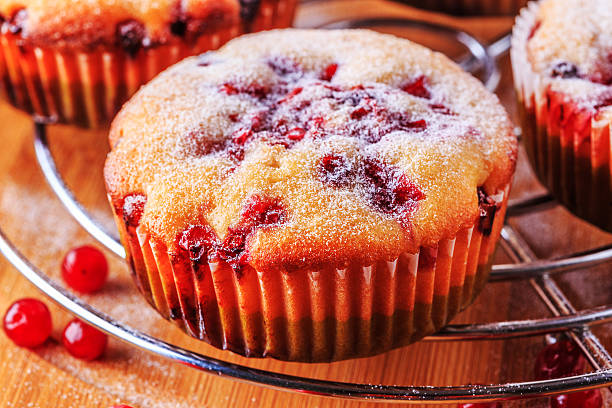 istock Cranberry muffins on a wooden background. 516721810