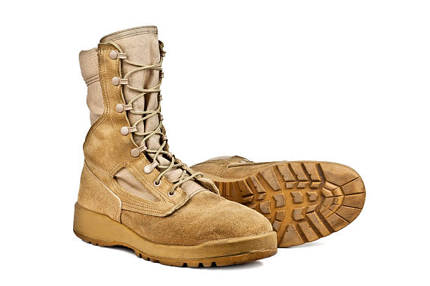 istock standing and lying army boots isolated on white background 516723620