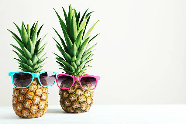 istock Ripe pineapples on a white wooden table 516724774