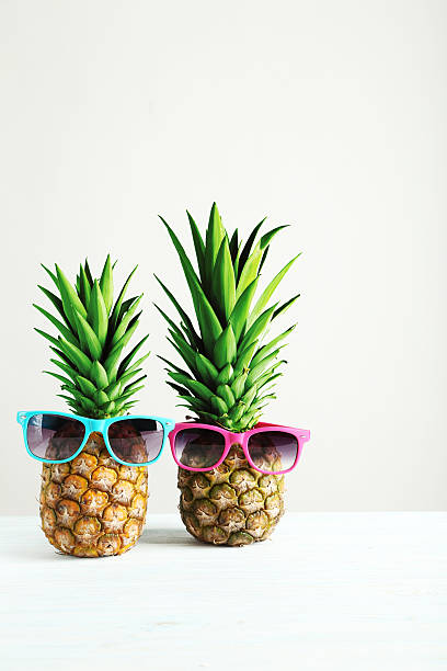 istock Ripe pineapples on a white wooden table 516724828