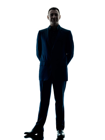 one caucasian business man standing silhouette isolated on white background