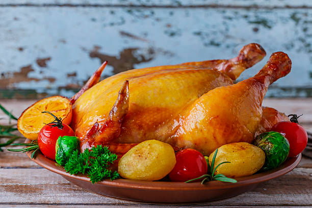 istock baked whole chicken with vegetables 516725795