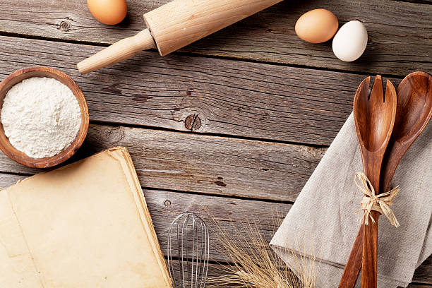 istock Kitchen table with cookbook, utensils and ingredients 516725908