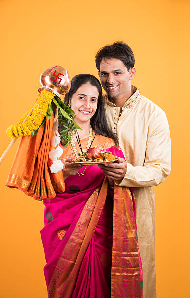istock smart indian couple performing gudhi padwa puja 516726040