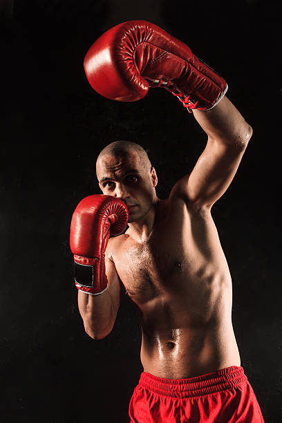 istock The young man kickboxing on black 516726520
