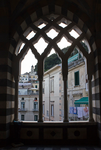 Amalfi, Italy, August 11, 2014: Amalfi Cathedral  (it.Duomo di Amalfi), external colonnad window detaile. The church is dedicated to the Apostle Saint Andrew. Predominantly of Arab-Norman Romanesque architectural style
