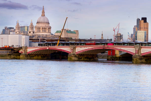 Skyline of London with Blackfriars Bridge and St Paul's cathedral over Thames river.