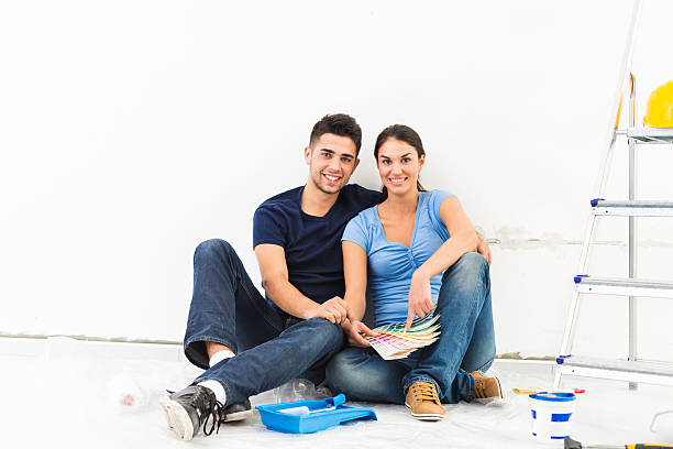 istock Couple choosing wall paint for new home 516727120