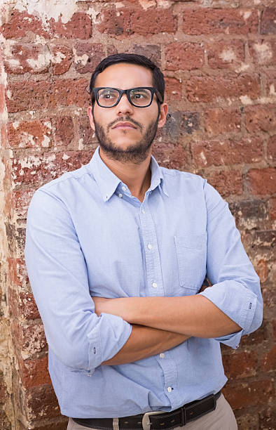 istock Thoughtful businessman against brick wall 516727545