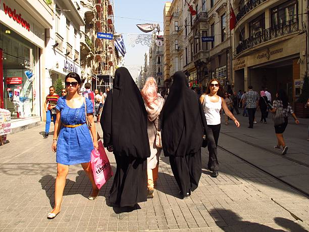 Istanbul Istikal Caddesi women in burkas and Western clothes stock photo