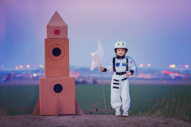 istock Adorable little boy, dressed as astronaut, playing in the park 516728416