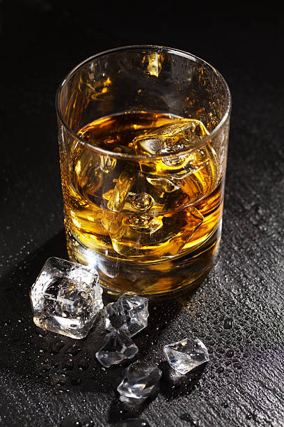 istock Glass of whiskey with ice 516729354