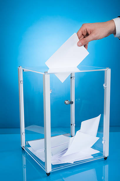 istock Businessman Putting Paper In Election Box 516729503