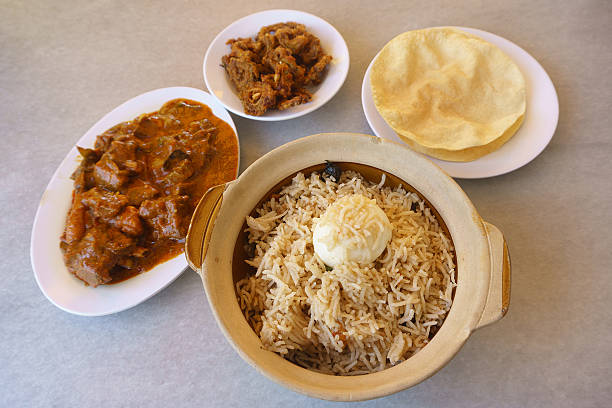 istock Delicious Indian biryani rice inside claypot on table setup. 516729646