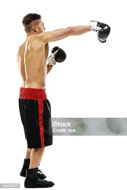 Muscular Boxer Punching Stock Photo - Download Image Now - 20-29 Years, Activity, Adult