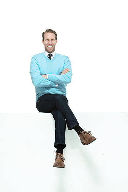 istock Cheerful man in sweater sitting on box 516730275