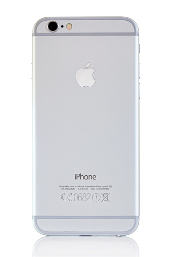 Hertfordshire, UK - October 5, 2014: Studio shot of a back of a white and silver iPhone 6 showing the Apple logo, camera and flash. Isolated on white.