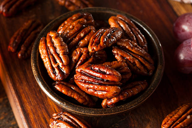 Homemade Candied Pecans with Cinnamon Homemade Candied Pecans with Cinnamon and Sugar candied fruit stock pictures, royalty-free photos & images