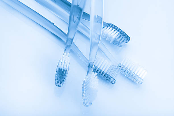 istock tooth brush and toothpaste in glass on white background 516732081