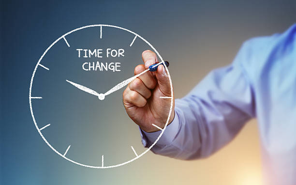 Time for change Businessman hand drawing a clock on whiteboard with time for change concept for planning, improvement and progress hour hand stock pictures, royalty-free photos & images