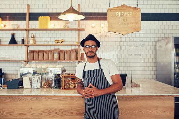 istock Young coffee shop owner standing at the counter 516755174