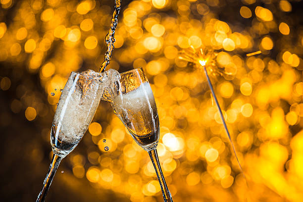 istock New Year's at midnight with champagne glasses on light background 516755264