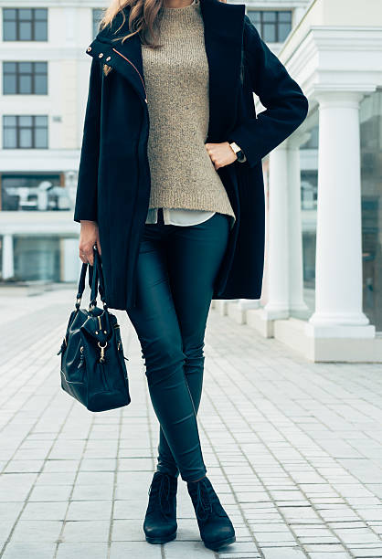 istock Woman in a sweater, black coat and pants 516755308