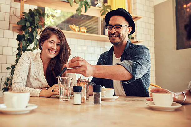 istock Young friends looking at smart phone while sitting in cafe 516755376