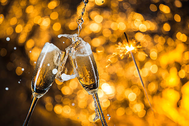 istock New Year's at midnight with champagne glasses on light background 516755556