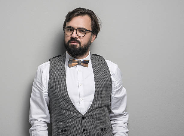 Portrait of businessman over isolated gray background. Horizontal composition, studio shot. Image taken with Sony A7RII developed from camera RAW.