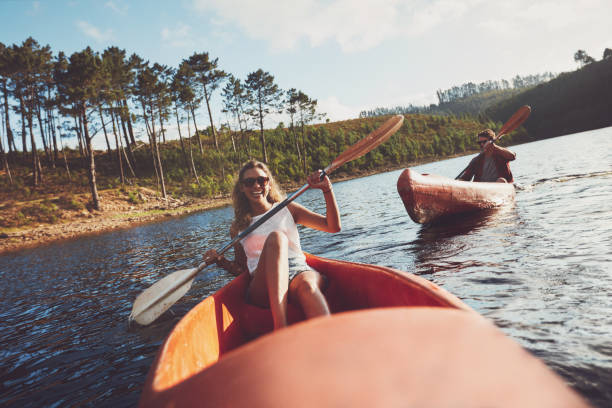 istock Happy kayakers rowing on a lake 516756706
